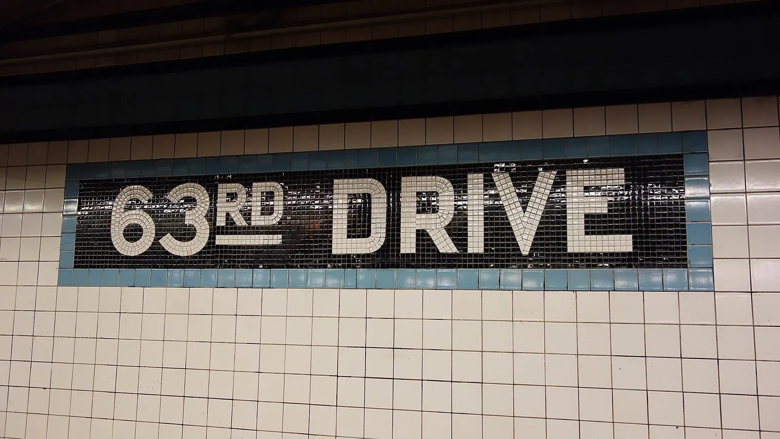 63rd Drive station mosaic sign on the Queens Boulevard subway line in Rego Park
